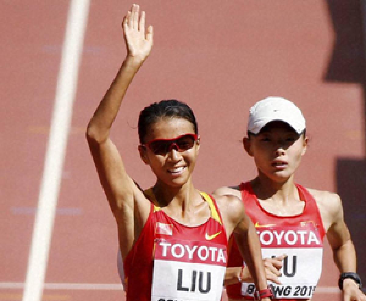 China's Liu Hong celebrates after winning the women 20k race walk in the World Athletics Championships  at the Bird's Nest Stadium in Beijing on Friday